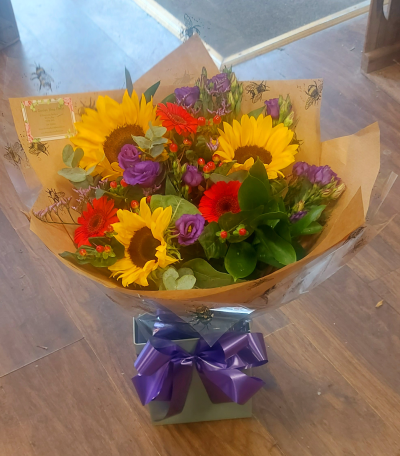 Ray of Sunshine - Send good vibes with this funky cheeful colourful collection of flowers to brighten their day. A bouquet that doesnt just sit there is this vibrant combination literally shines. A mixed hand tied bouquet of sunflowers and germini. No need for the recipient to arrange the flowers as they have already been hand tied by a proffesional florist here in Whitley Bay. A wonderful gift for many occasions perfect for Birthdays especially for a Germini sign!, Congratulations, Get well, Thank you.  Beautifully presented and personally delivered by The Garden Shop Florist .

Subject to availability any issues with the flowers choice you will be contacted by one of our team here at The Garden Shop Florist. If you have any special requests to go with your bouquet please contact one of the team on 0191 2522553 or by email at thegardenshopflorist@hotmail.com. Our opening hours are Tuesday to Friday 9.30 till 4.30 Saturday 10 till 2.