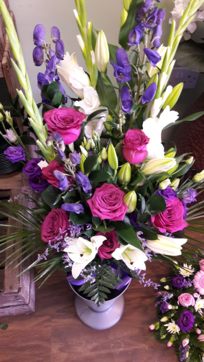 Mixed tied sheaf - Bright beautiful funeral tributes hand made in Whitley Bay by The Garden Shop Florist.
Order online today for flower delivery in Whitley Bay