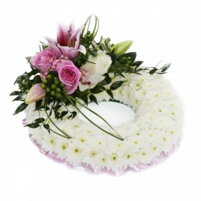 White based wreath with top spray - Funeral flowers delivered in Whitley Bay by The Garden Shop Florist. Order online today